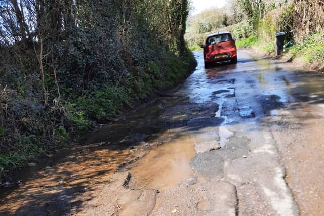 The pot holes on Golden Valley Lane, and the stranded vehicle driven by Jill Hireson