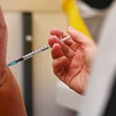 A member of the public receives a dose of the Pfizer BioNtech vaccine at a vaccination centre (Getty Images)