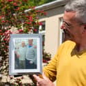 Leigh Blanning with a photo of his late father John