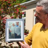 Leigh Blanning with a photo of his late father John