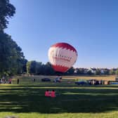 Hundreds line the perimeter of Redcatch Park to see the balloon go up in the sky