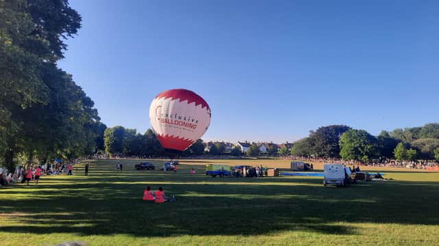 Hundreds line the perimeter of Redcatch Park to see the balloon go up in the sky