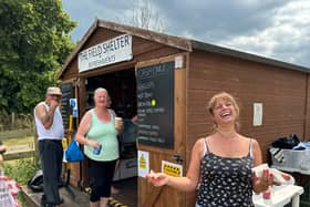 Nikki Lewis runs the food stall. It started as a gazebo, but not its a wooden hut and today she’s busy selling everything from coffee to hot dogs to hunger buyers and sellers. 