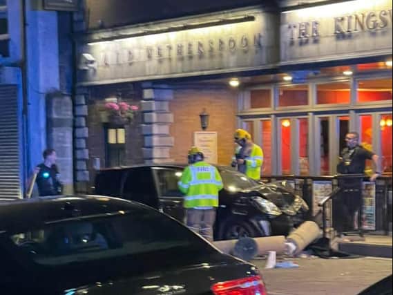 Emergency services tend to the car which smashed into a pillar at the front of Kingswood Colliers pub (Submitted picture)