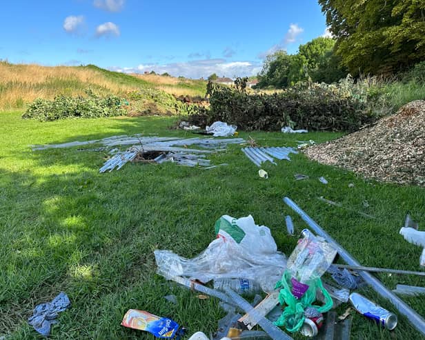 The dumped waste appears to be a mix of garden and household waste, potentially from home clearances