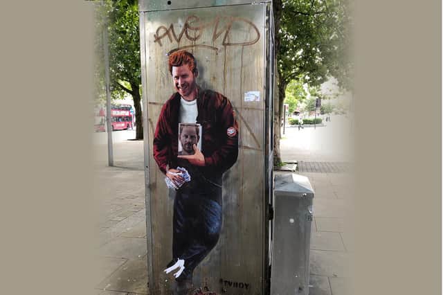 Street art showing Prince Harry holding a book and a wad of cash has appeared in Bristol city centre