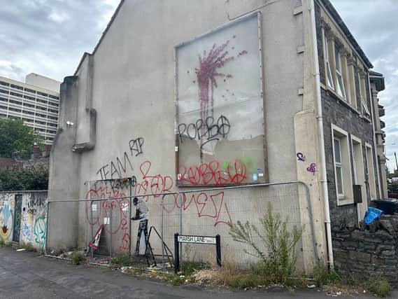 The wall where Banksy’s Valentine’s Day artwork has been tagged repeatedly with the term ‘Robbo'