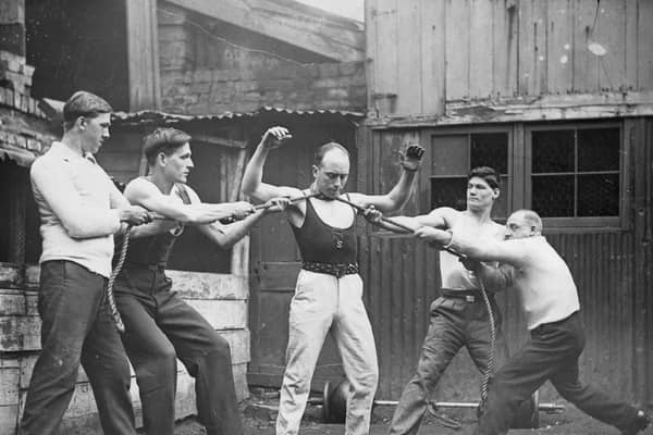 Tom Joyce, who claimed to be Bristol’s strongest man, showing his strength by four men pulling at a rope which is tied around his neck in 1932.