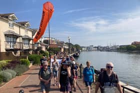 Bristol Airport expansion campaigners walk through the harbourside on their protest pilgrimage 