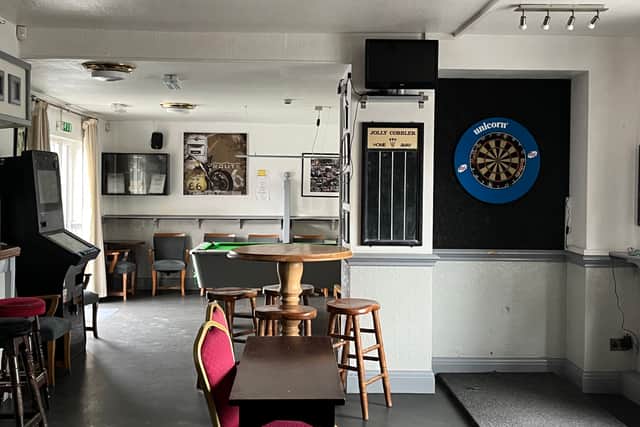 The pub has a dart board and a pool table, which is free all day on Mondays