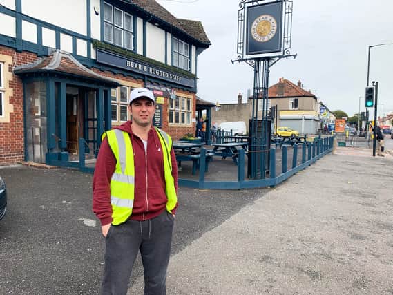 Jody Kamali as his alter ego Terry the Odd Job Man outside his local pub in Southmead
