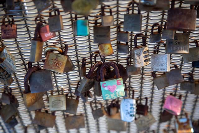 A campaign has been launched to remove hundreds of 'lovelocks' from a bridge - as they are a 'symbol of oppression'