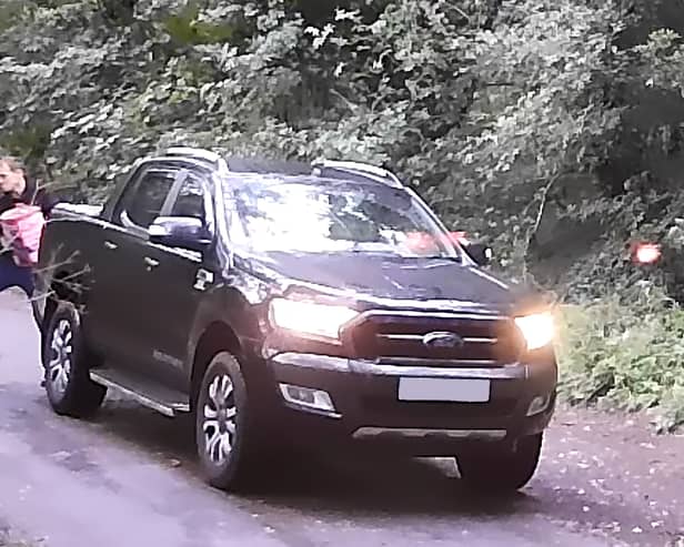 A video clip showed a male taking items out of the rear of a Ford Ranger pick-up truck and throwing them into the woodland