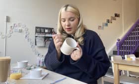 Emma May Jones tries her hand at painting a mug at Flying Saucers