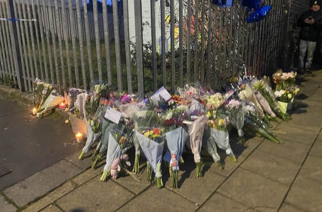 Floral tributes have started to appear on the street where two teenagers were stabbed to death (photo: Charlie Watts/Bristol World)