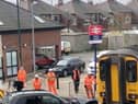 Network Rail staff work to remove an SUV from the track after it was hit by a train on a crossing at Redcar Central, Middlesbrough, on Wednesday May 1 2024. 