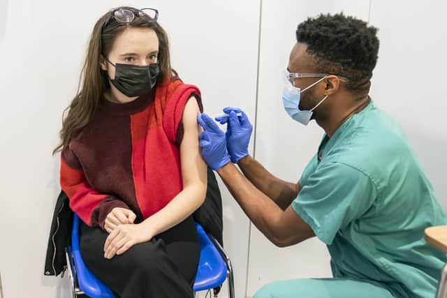 Associate Practitioner Alex Iheanacho (right) administers a booster coronavirus vaccine to Shona McCauley (left) at a Covid vaccination centre at Elland Road in Leeds, as the booster vaccination programme continues across the UK. Picture: Danny Lawson