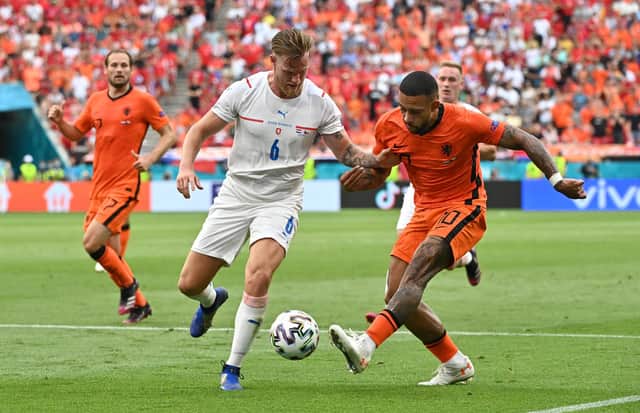 BUDAPEST, HUNGARY - JUNE 27: Memphis Depay of Netherlands crosses the ball whilst under pressure from Tomas Kalas of Czech Republic during the UEFA Euro 2020 Championship Round of 16 match between Netherlands and Czech Republic at Puskas Arena on June 27, 2021 in Budapest, Hungary. (Photo by Tibor Illyes - Pool/Getty Images)