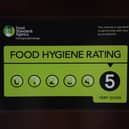 A Food Standards Agency rating sticker on a window of a restaurant