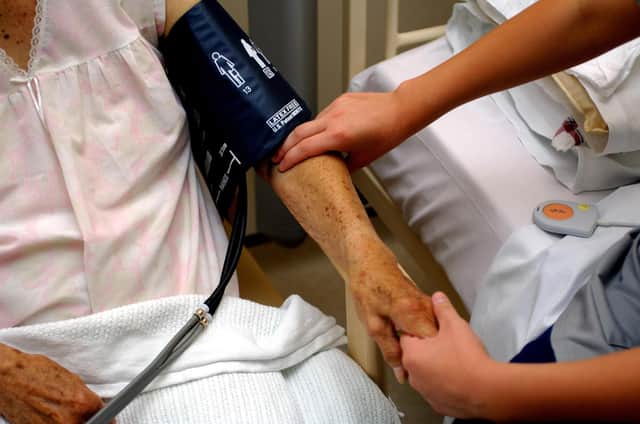 Generic stock picture of a nurse taking the blood pressure of an eldery patient at Derby City Hospital.