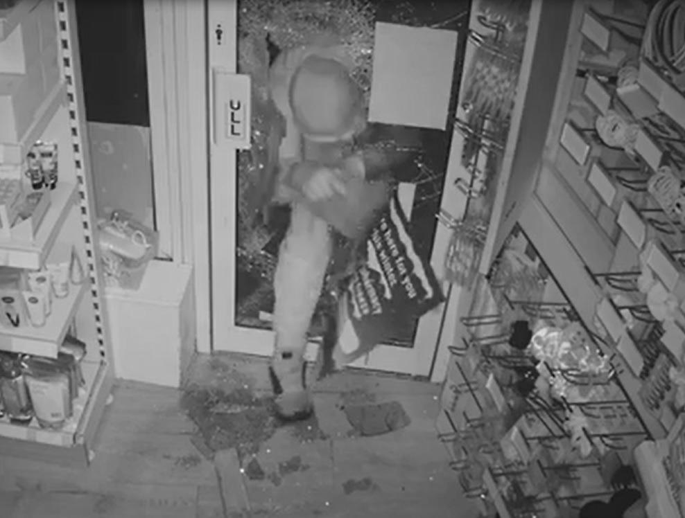 Caught on CCTV: Burglar breaks into pharmacy...then drops bag of stolen goods