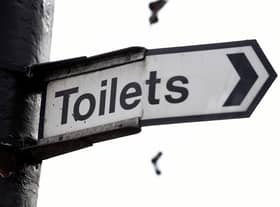 A sign for public toilets in London. Spending by councils in England on basic services such as public toilets, road safety and pest control has fallen as much as 40\% since 2010.