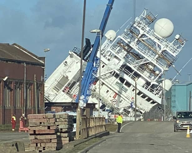 A ship is currently leaning towards the docks at a worrying angle in Leith, Edinburgh. (Photo credit: @Tomafc83 on Twitter)