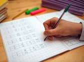 File photo dated 05/03/2017 of a primary school teacher marking a pupil's maths homework. Children in the "best-off" homes were more likely to report having had private tutoring than their peers in the "worst-off" homes (35% compared with 21%), according to the Sutton Trust report. A survey of 2,394 schoolchildren aged 11 to 16 in England and Wales found that 30% said they have had private tuition, up from 27% pre-pandemic. The proportion is the joint highest figure since the survey began in 2005, when it stood at 18%. Issue date: Thursday March 9, 2023.