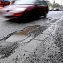 A car driving around a pothole on the road. PIC: Ben Birchall/PA Wire