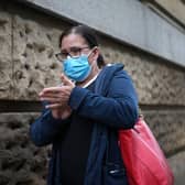 A member of the public wears a pandemic face mask ahead of the prime minister announcing the government's Covid-19 winter strategy.