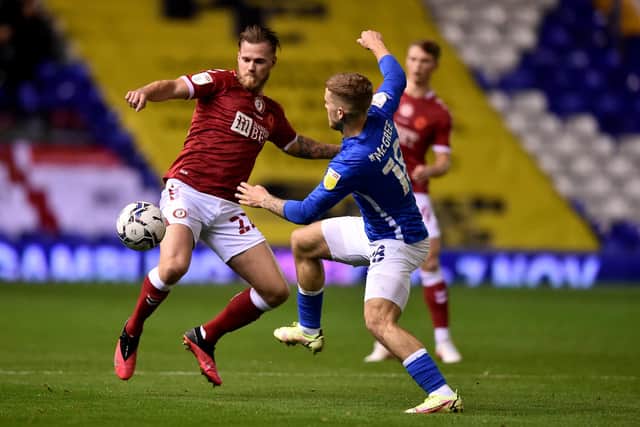 BIRMINGHAM, ENGLAND - NOVEMBER 02: Tomáš Kalas of Bristol City is challenged by Riley McGree of Birmingham City during the Sky Bet Championship match between Birmingham City and Bristol City at St Andrew's Trillion Trophy Stadium on November 02, 2021 in Birmingham, England. (Photo by Nathan Stirk/Getty Images)