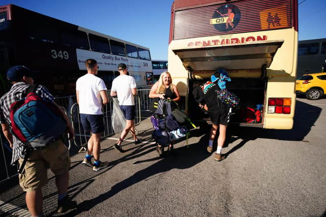 People board a bus at Castle Cary station heading to the Glastonbury Festival at Worthy Farm in Somerset.