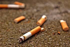 A woman has been fined close to £1,500 for dropping a single cigarette in Staple Hill. 